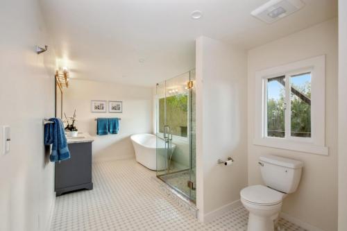 Double vanity, glass shower and free standing soaking tub